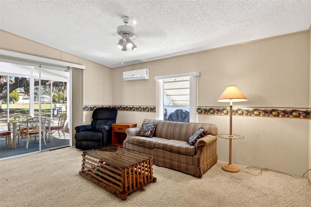 8046 Highpoint Boulevard Brooksville, FL 34613 - Photo 21 of 47 a living room with furniture and a large window