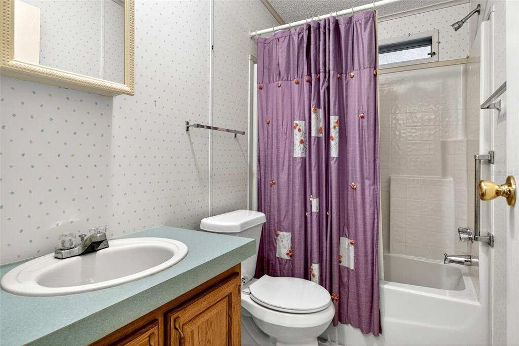 8046 Highpoint Boulevard Brooksville, FL 34613 - Photo 25 of 47 a bathroom with a sink a toilet and shower