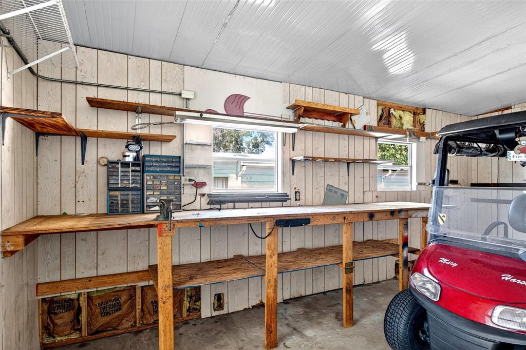 8046 Highpoint Boulevard Brooksville, FL 34613 - Photo 31 of 47 a kitchen with a sink a stove and chairs