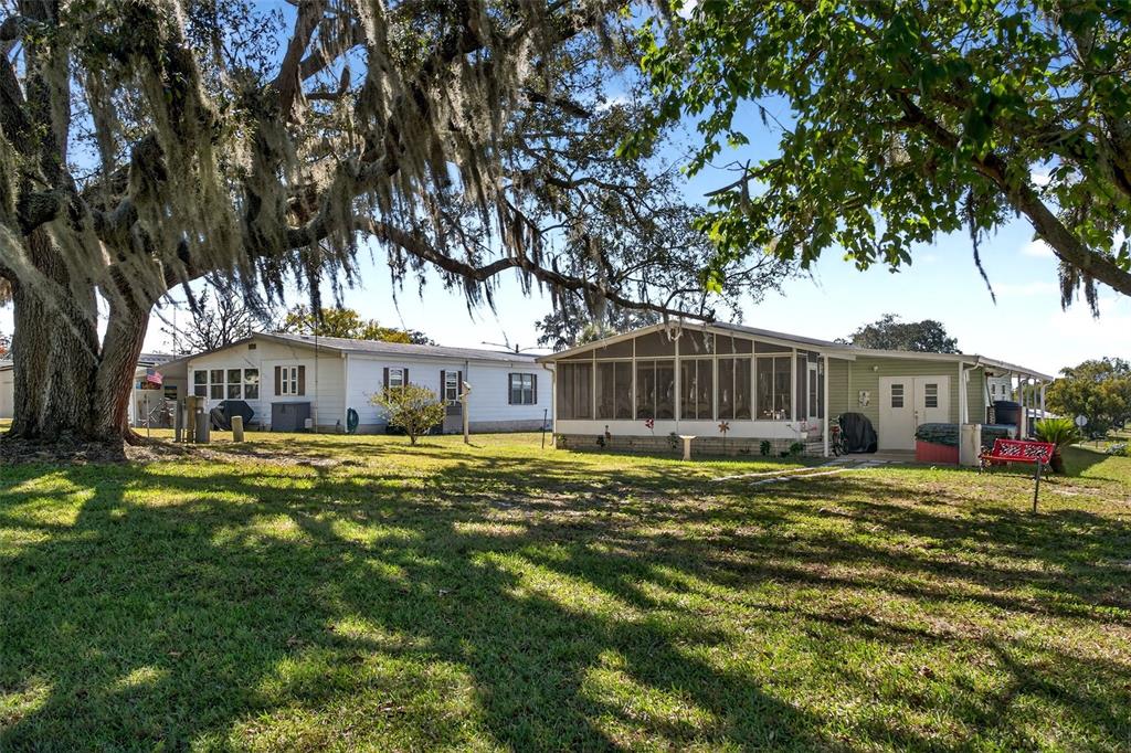 8046 Highpoint Boulevard Brooksville, FL 34613 - Photo 34 of 47 a front view of a house with a yard