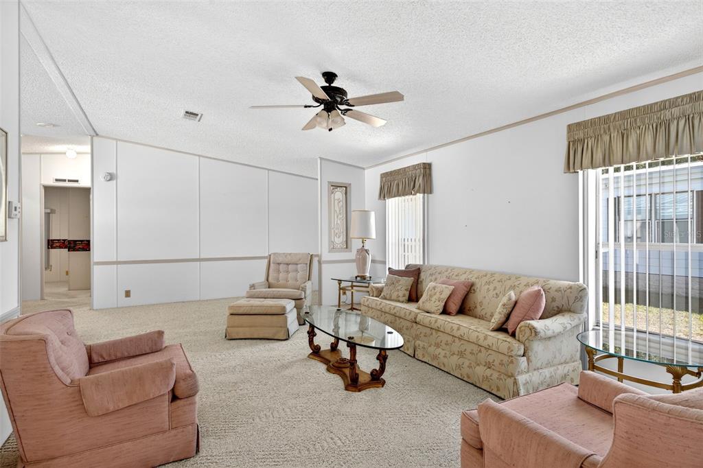 8046 Highpoint Boulevard Brooksville, FL 34613 - Photo 8 of 47 a living room with furniture and a large window