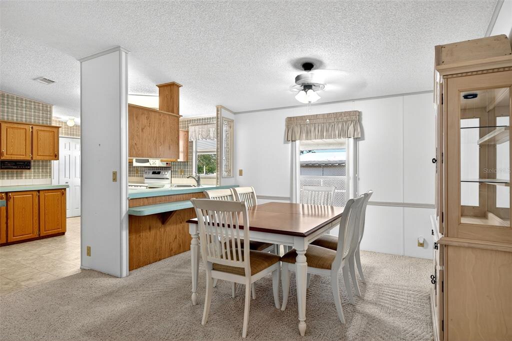 8046 Highpoint Boulevard Brooksville, FL 34613 - Photo 9 of 47 a dining room with furniture and window