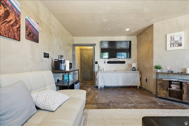 1634 West Arimo Road Arimo, ID 83214 - Photo 35 of 89 Distressed concrete flooring complements textured wall finishes and a built-in entertainment area