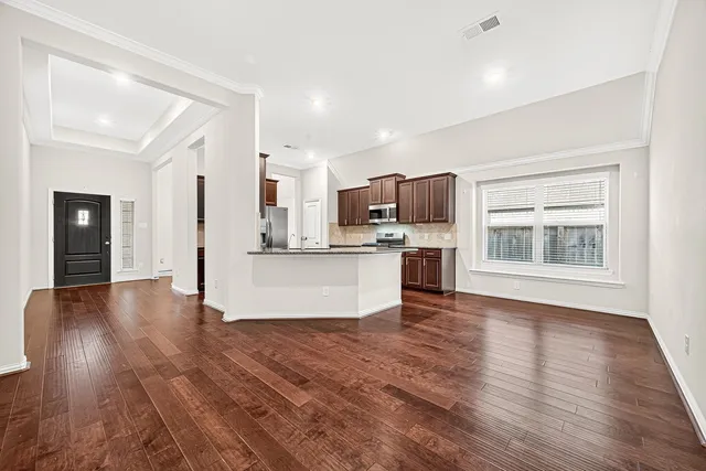 a view of kitchen with microwave and refrigerator