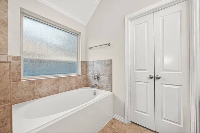 a white bath tub sitting next to a shower