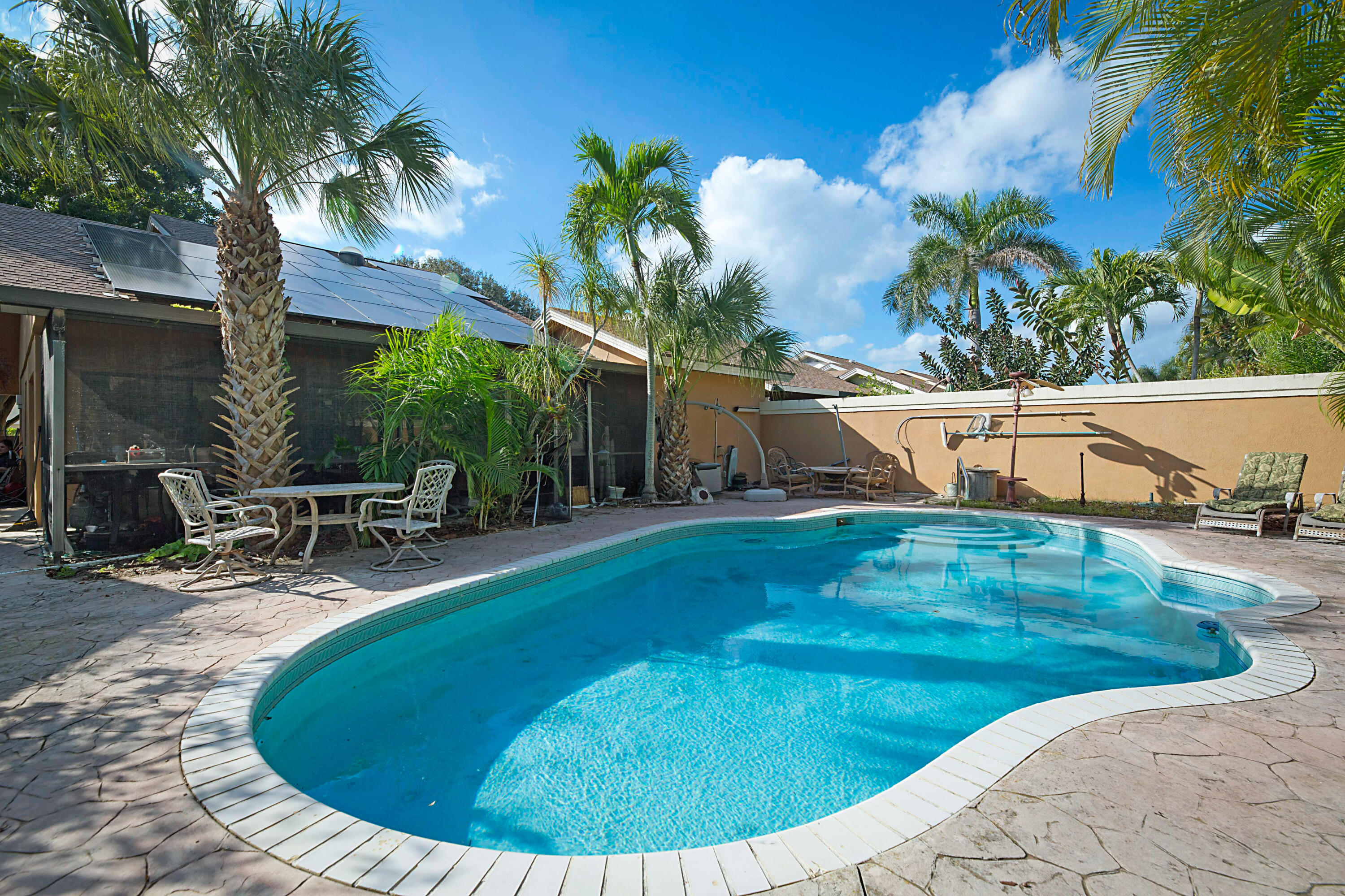 113 Seashore Drive Jupiter, FL 33477 - Photo 10 of 19 a view of a swimming pool with a patio