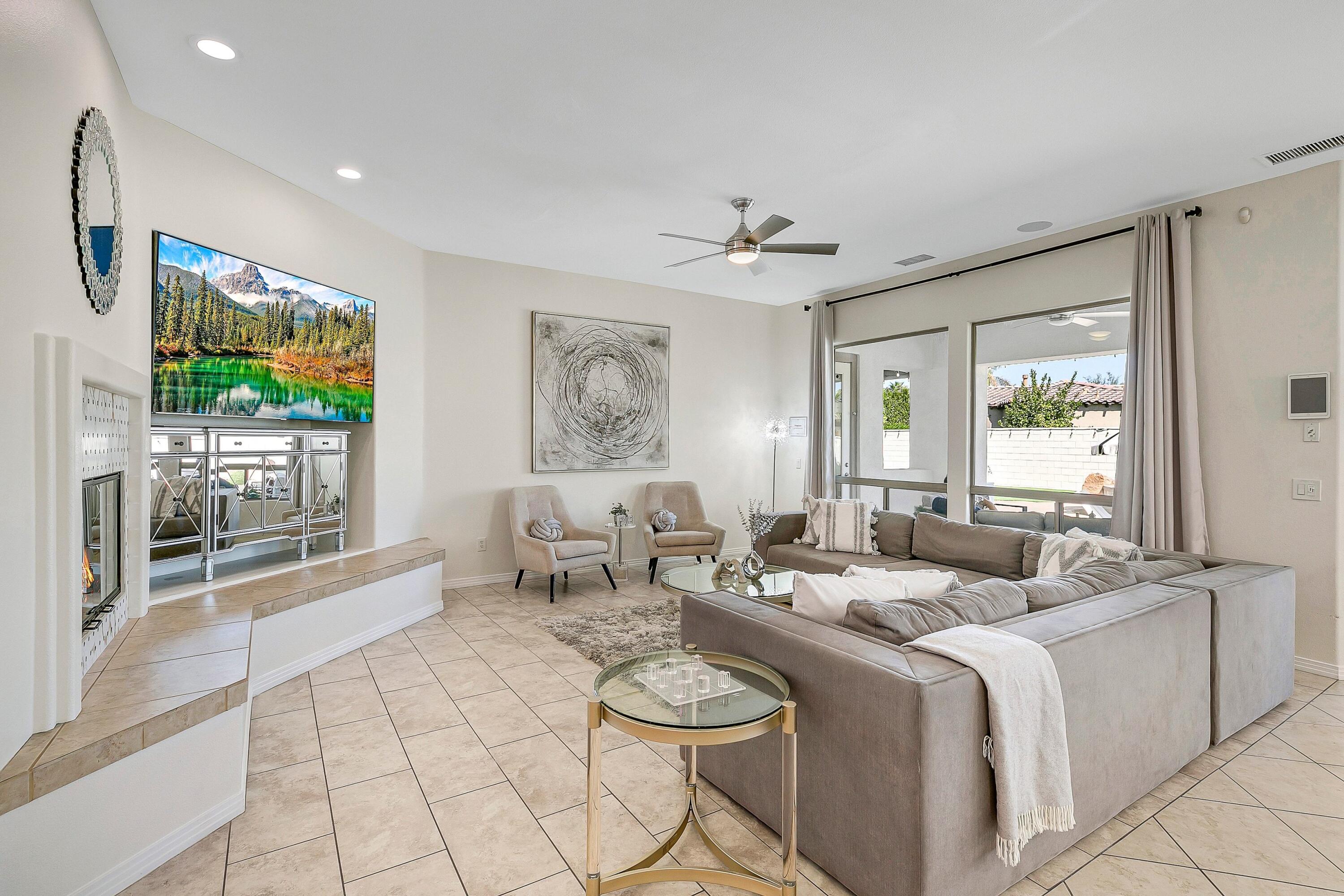48678 Cascade Street Indio, CA 92201 - Photo 16 of 78 a living room with furniture a flat screen tv and a large window