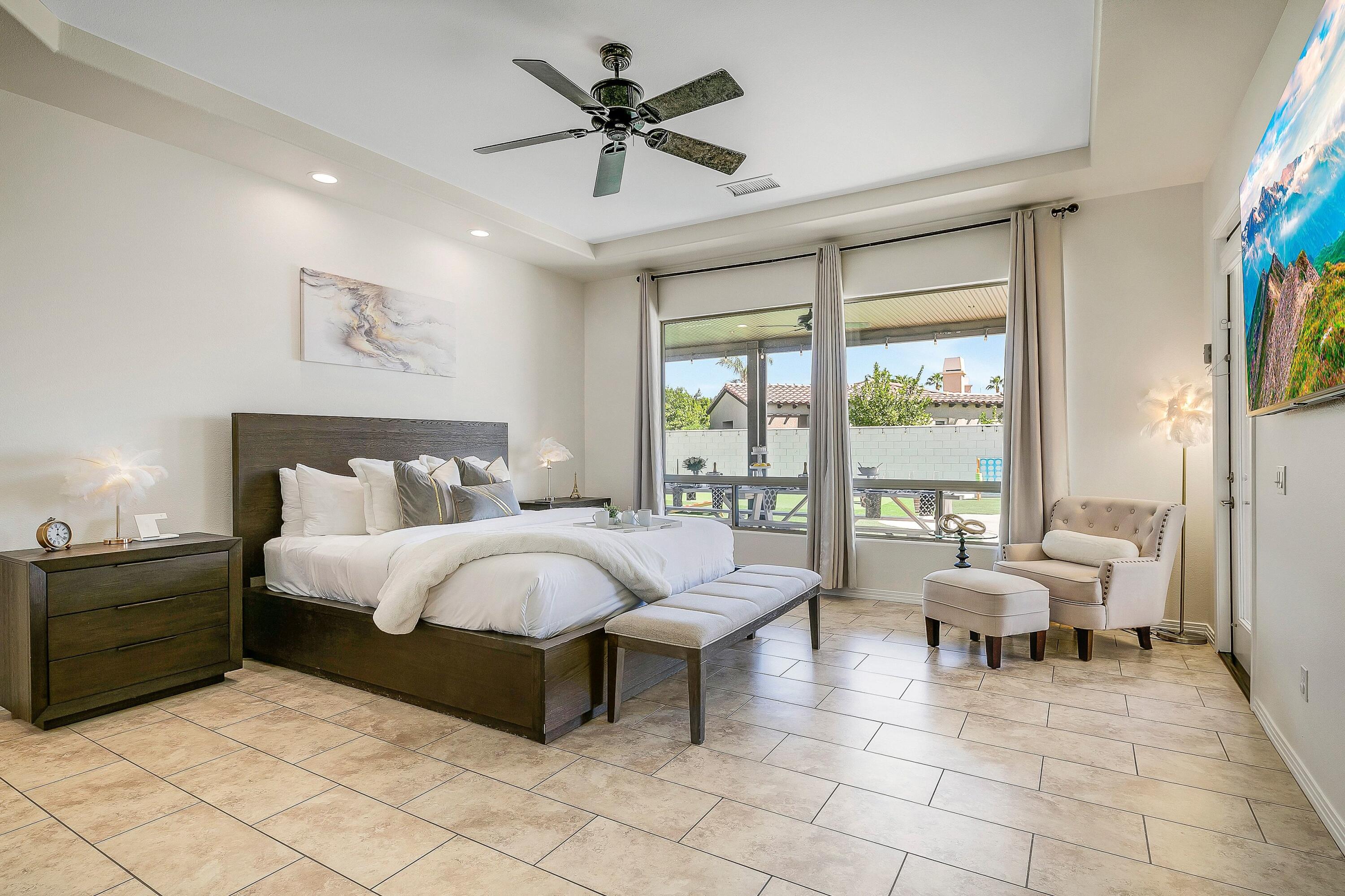 48678 Cascade Street Indio, CA 92201 - Photo 23 of 78 a spacious bedroom with a bed and glass walk in closet