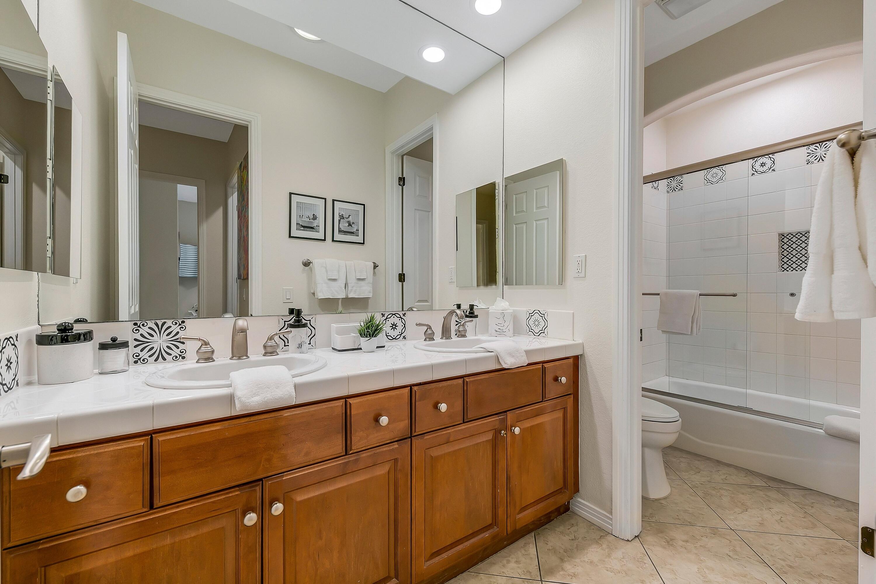 48678 Cascade Street Indio, CA 92201 - Photo 36 of 78 a bathroom with a double vanity sink toilet mirror and bathtub