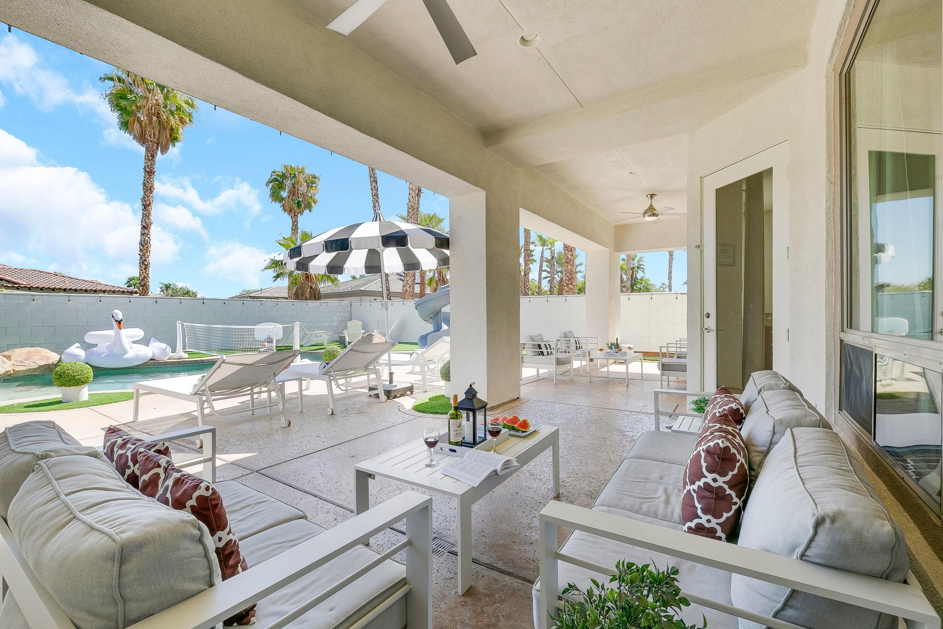 48678 Cascade Street Indio, CA 92201 - Photo 59 of 78 a living room with furniture and a floor to ceiling window