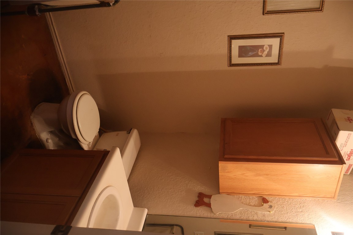 4523 Secure Lane Austin, TX 78725 - Photo 4 of 10 Half bath with a textured wall and vanity