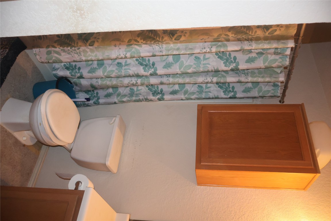 4523 Secure Lane Austin, TX 78725 - Photo 6 of 10 Full bath with vanity, a shower with shower curtain, and a textured wall