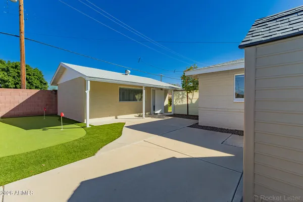 a view of a kitchen with wooden floor and a refrigerator