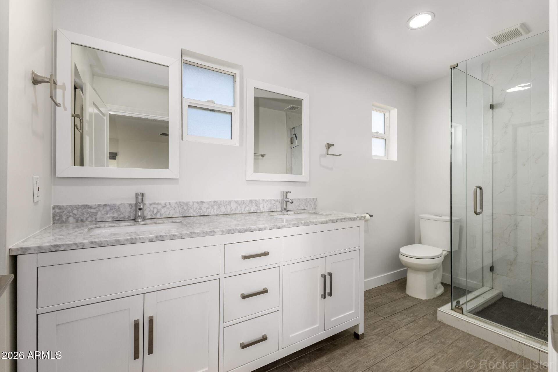 3930 East Oak Street Phoenix, AZ 85008 - Photo 35 of 61 a bathroom with a granite countertop toilet sink and mirror