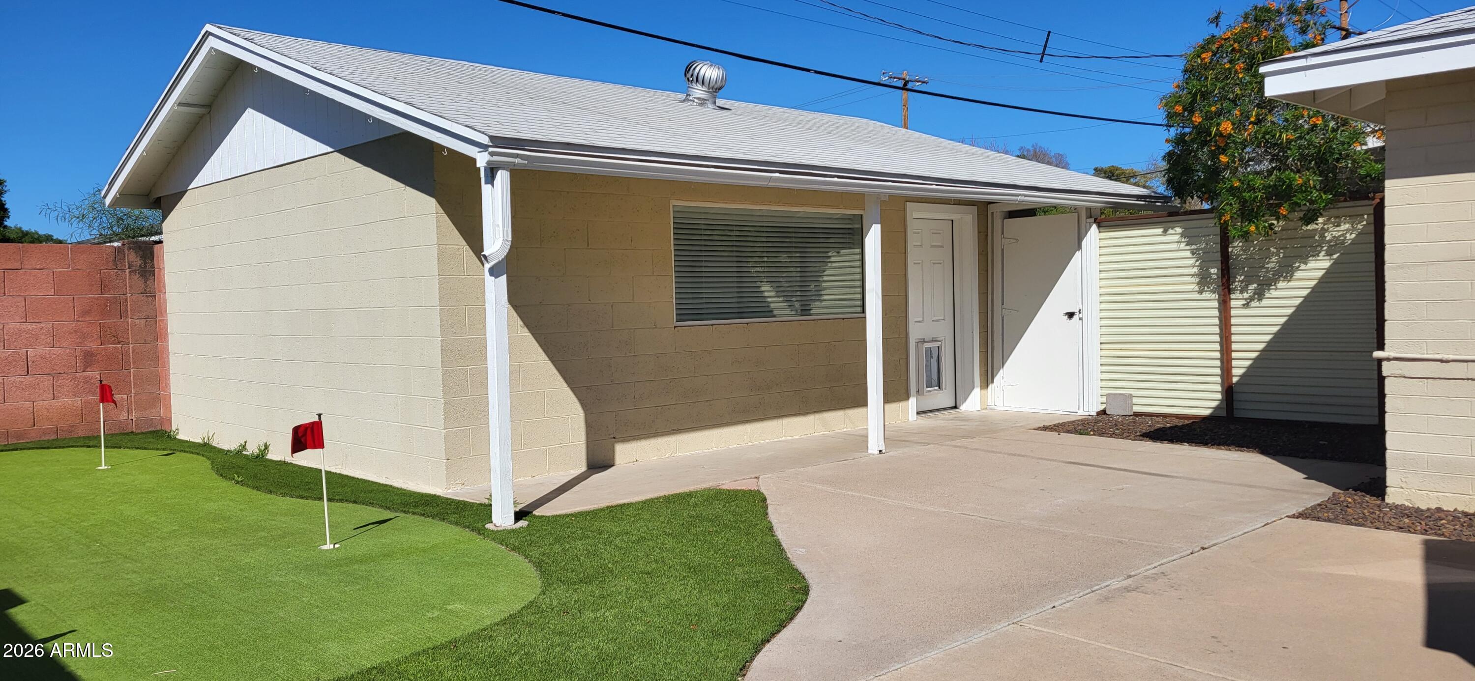 3930 East Oak Street Phoenix, AZ 85008 - Photo 53 of 61 a front view of a house with a yard