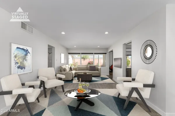 a view of a livingroom with an empty space & workspace