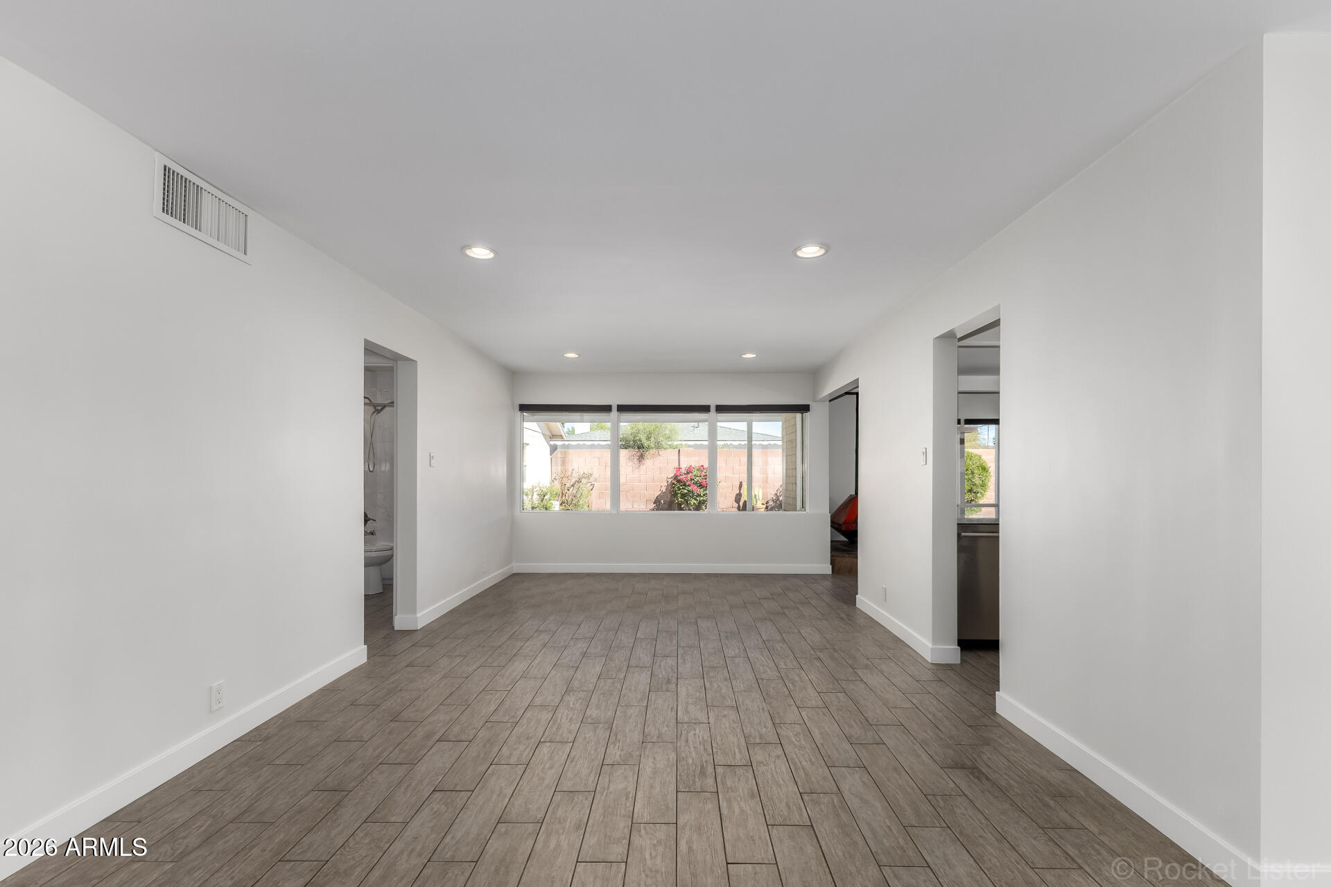 3930 East Oak Street Phoenix, AZ 85008 - Photo 7 of 61 wooden floor in an empty room with a window