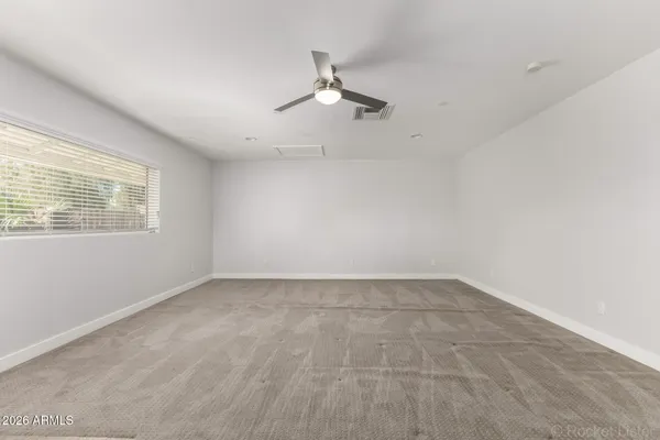 a view of wooden floor and windows in a room