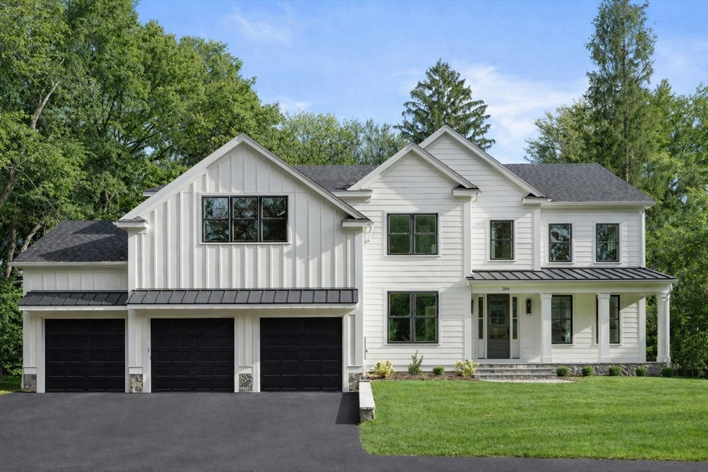 201 Lowell Road Wellesley, MA 02481 - Photo 1 of 42 a front view of a house with a yard and garage