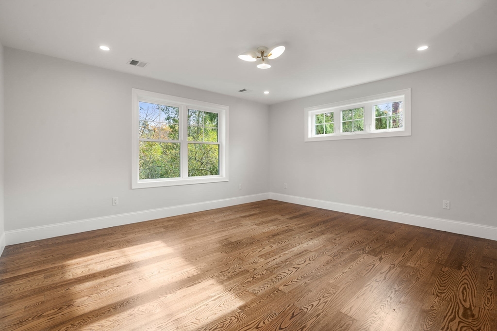 201 Lowell Road Wellesley, MA 02481 - Photo 11 of 41 a view of an empty room with wooden floor and a window