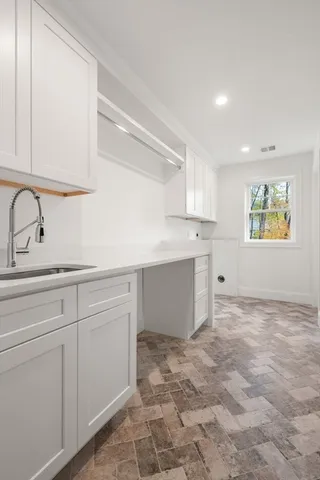 a kitchen with stainless steel appliances granite countertop a sink and cabinets