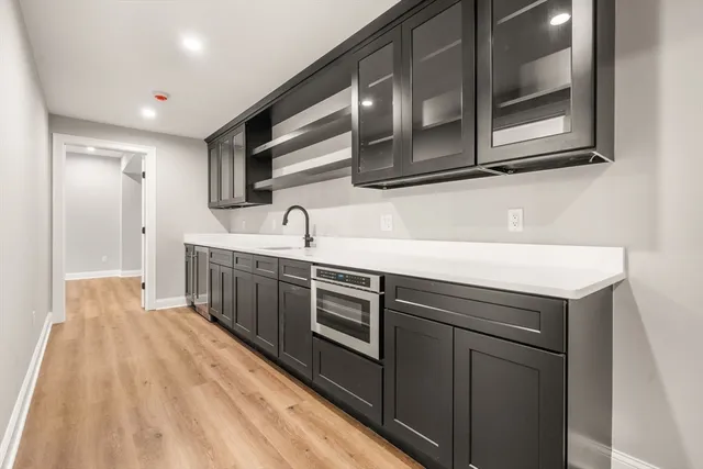 a living room with furniture a fireplace and a large window