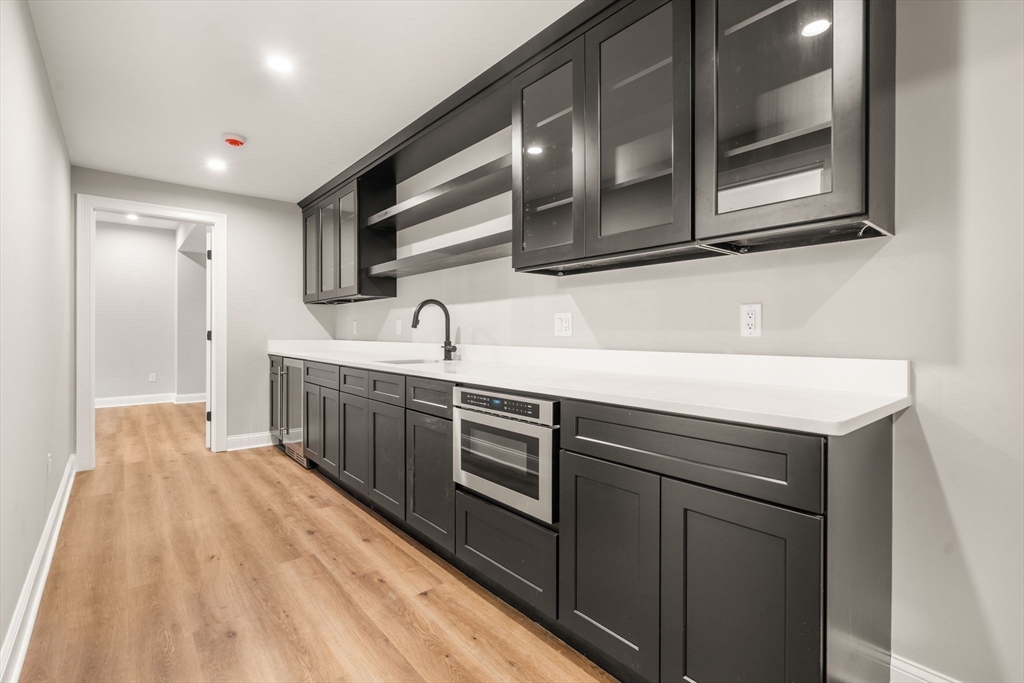 201 Lowell Road Wellesley, MA 02481 - Photo 21 of 41 a kitchen with stainless steel appliances granite countertop a sink and cabinets