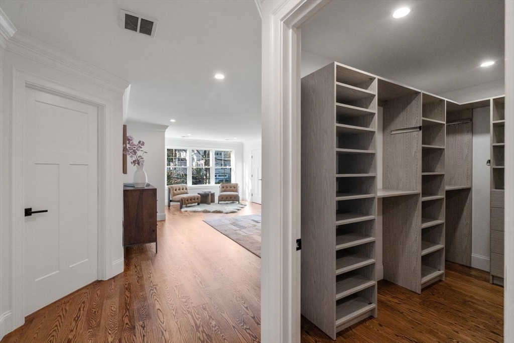 201 Lowell Road Wellesley, MA 02481 - Photo 24 of 42 a view of walk in closet with wooden floor and windows