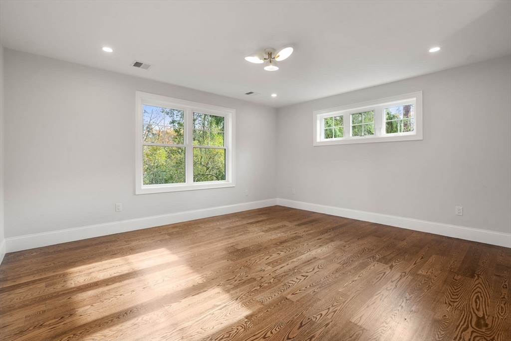 201 Lowell Road Wellesley, MA 02481 - Photo 28 of 42 a view of an empty room with wooden floor and a window