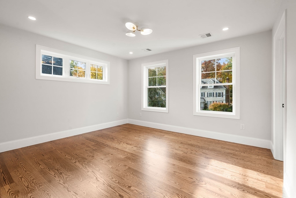 201 Lowell Road Wellesley, MA 02481 - Photo 31 of 42 a view of an empty room with a window and wooden floor