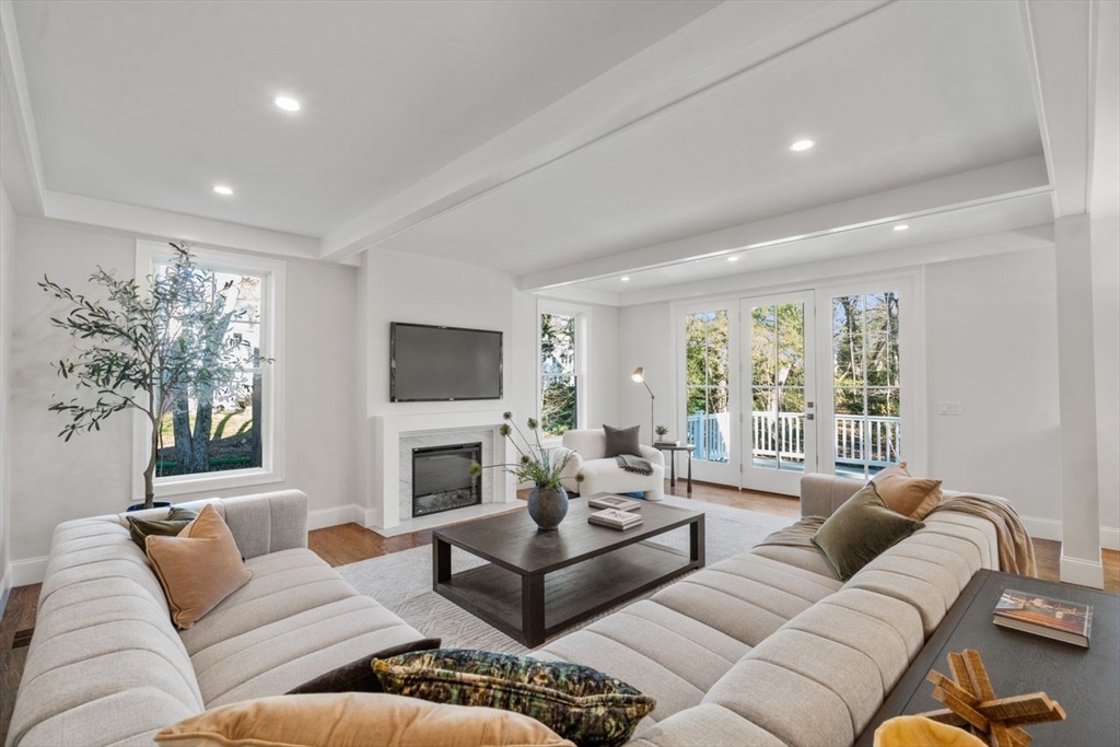 201 Lowell Road Wellesley, MA 02481 - Photo 35 of 41 a living room with furniture a large window and a flat screen tv