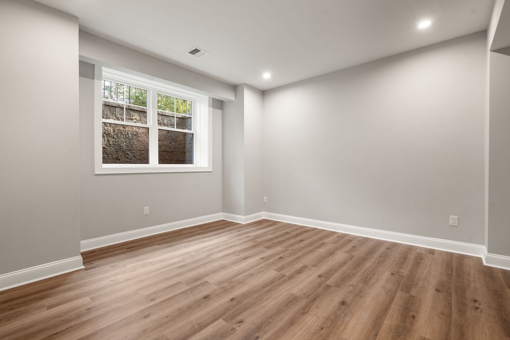 201 Lowell Road Wellesley, MA 02481 - Photo 39 of 42 an empty room with wooden floor and windows