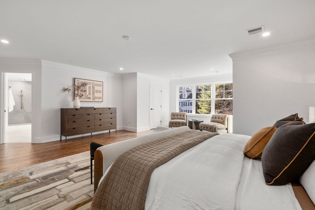 201 Lowell Road Wellesley, MA 02481 - Photo 40 of 41 a bedroom with a bed and wooden floor