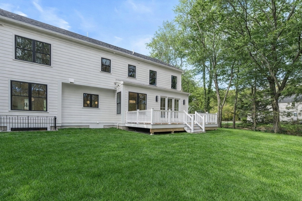 201 Lowell Road Wellesley, MA 02481 - Photo 41 of 42 a front view of house with a garden
