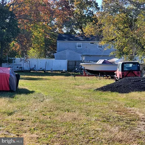 a view of a swimming pool with lawn chairs under an umbrella