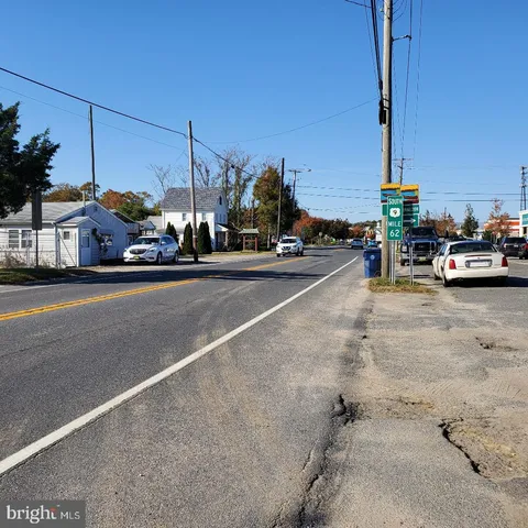a view of a street with a house in the background