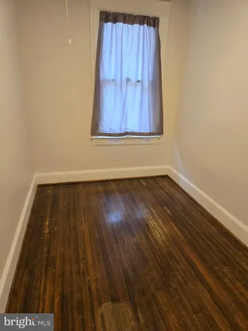 an empty room with wooden floor and closet