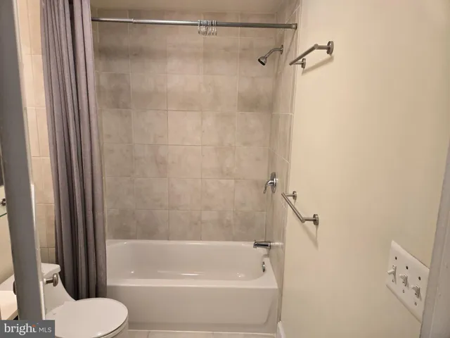 a bathroom with a shower and a toilet