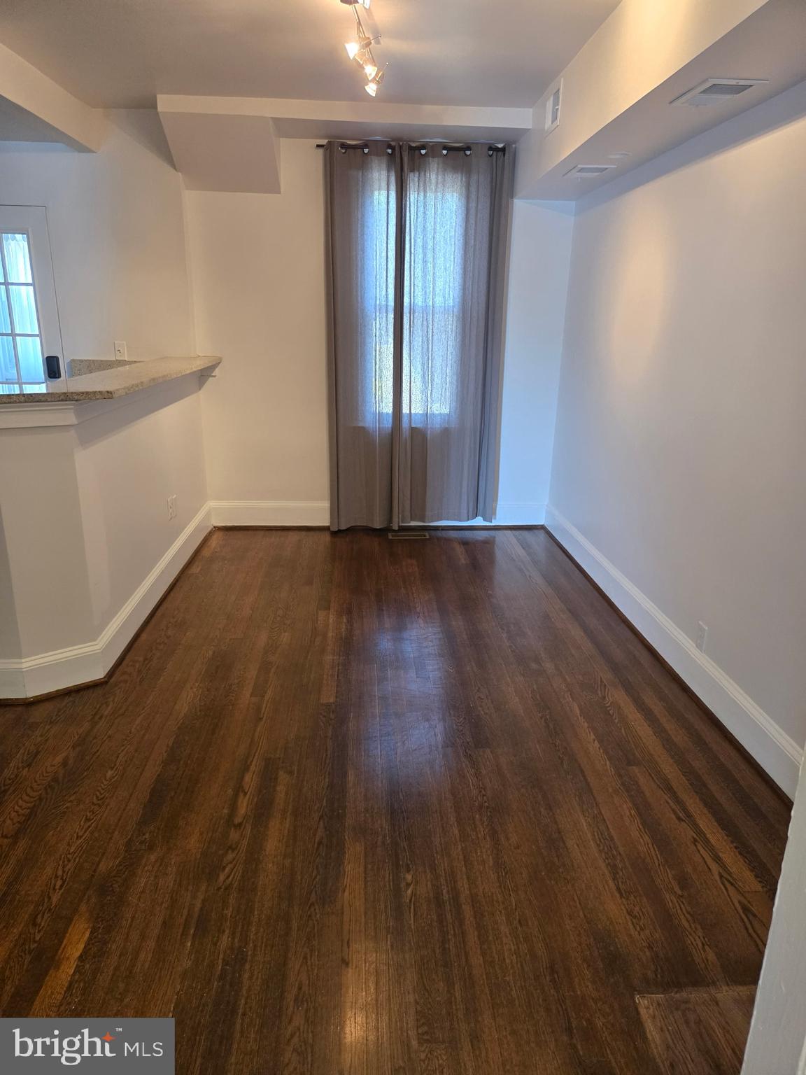1278 Neal Street Northeast Washington, DC 20002 - Photo 3 of 22 a view of an empty room with wooden floor and a window