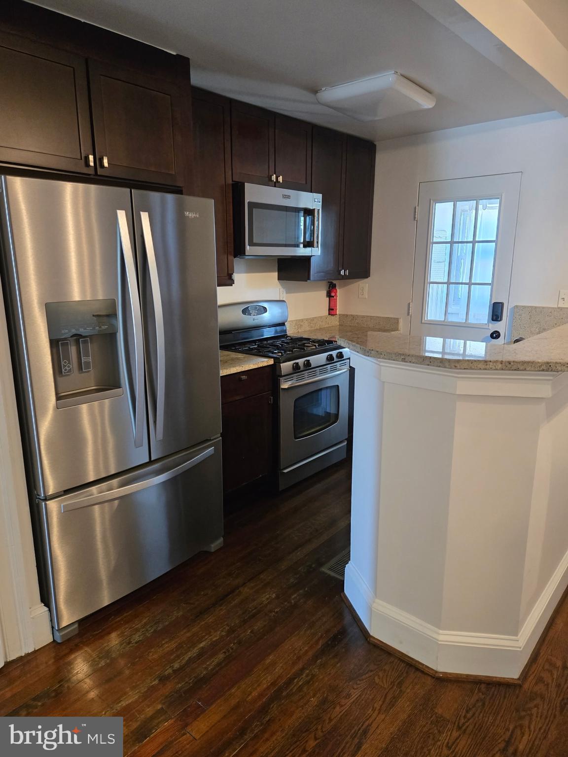 1278 Neal Street Northeast Washington, DC 20002 - Photo 4 of 22 a kitchen with stainless steel appliances granite countertop a refrigerator microwave and sink