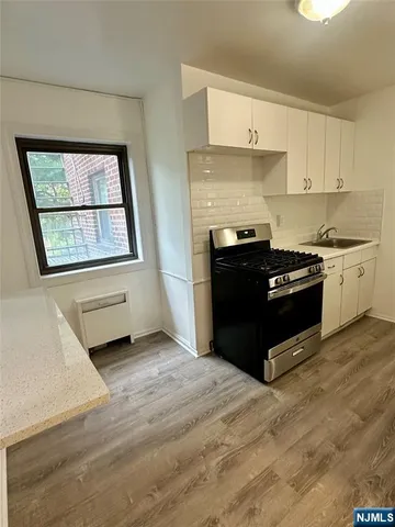 a kitchen with stainless steel appliances granite countertop a stove and a refrigerator