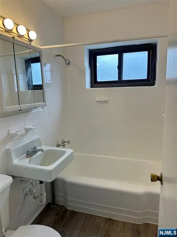 a bathroom with a sink a toilet and a bathtub