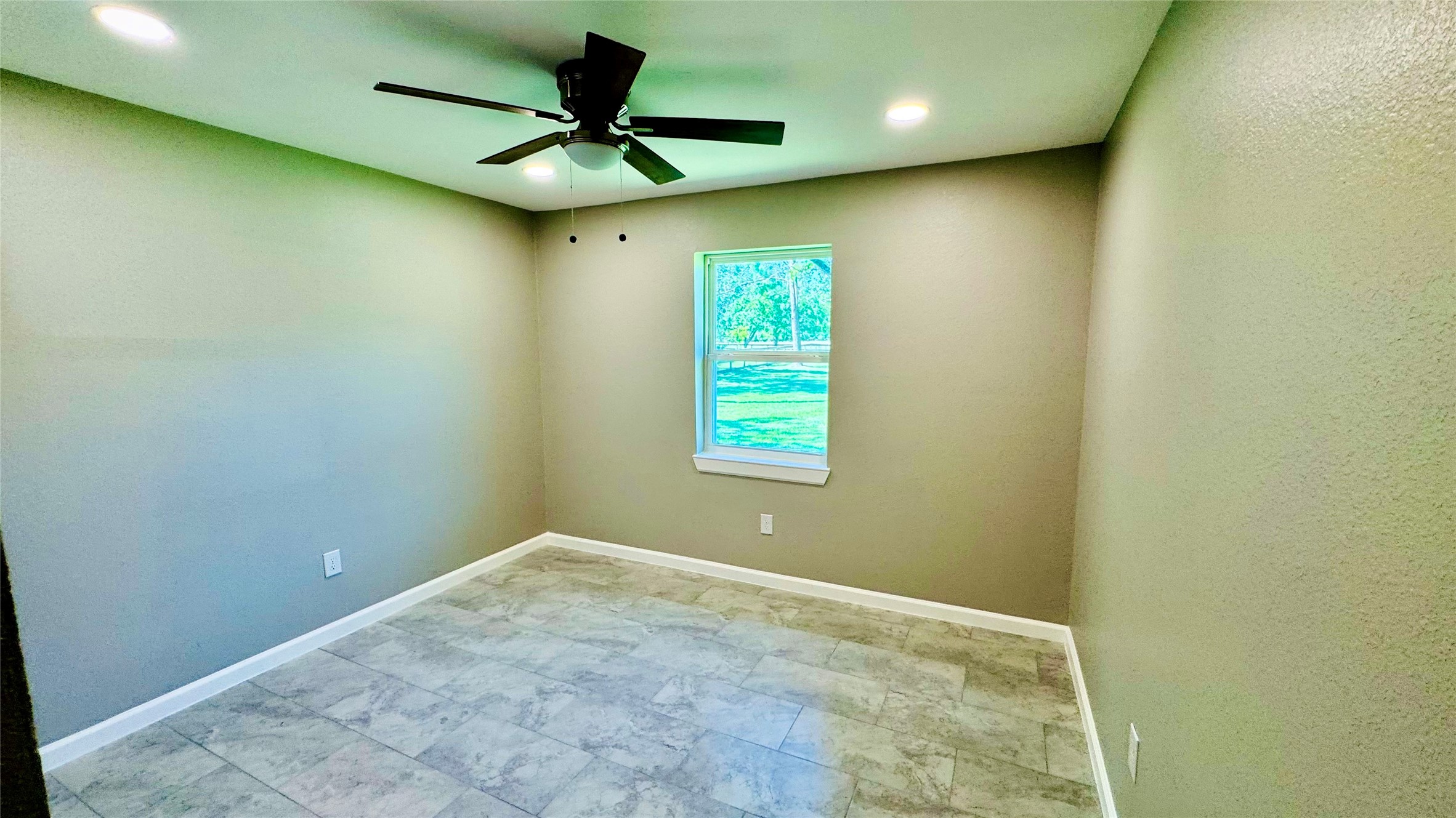 1434 County Road 878A Sweeny, TX 77480 - Photo 23 of 36 an empty room with a window and a fan