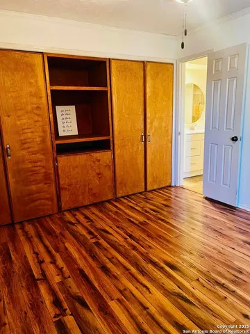 a view of a room with wooden floor and windows