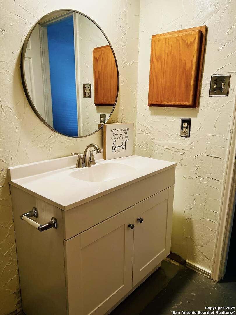 8655 Datapoint, Unit 404 San Antonio, TX 78229 - Photo 18 of 25 a bathroom with a sink and a mirror