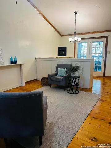 a view of a livingroom with furniture flat screen tv and window