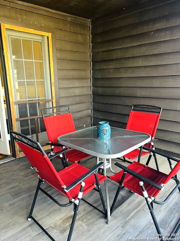 8655 Datapoint, Unit 404 San Antonio, TX 78229 - Photo 24 of 25 an outdoor sitting area with furniture and wooden floor