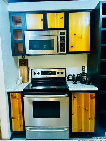 a kitchen with stainless steel appliances granite countertop a stove and a microwave