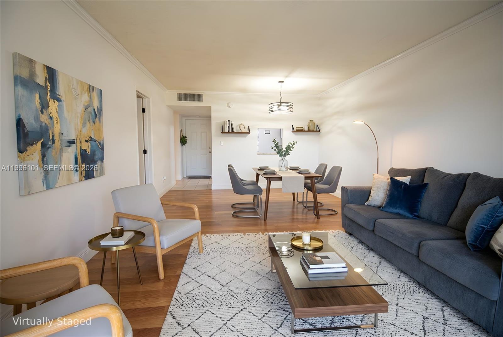 a living room with furniture and wooden floor
