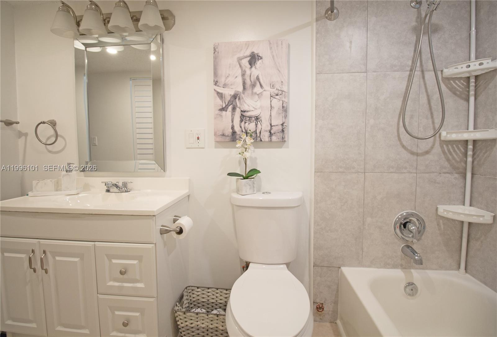 6020 Northwest 64th Avenue, Unit 108 Tamarac, FL 33319 - Photo 11 of 19 a bathroom with a sink a toilet and shower